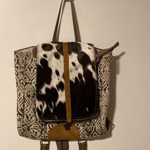 Black & white print, cowhide, leather trim with canvas & leather straps